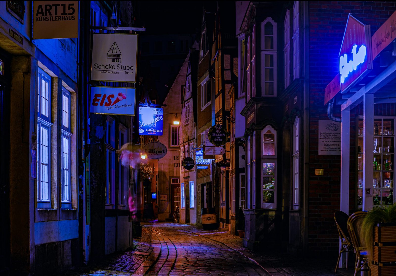 a city street at night with neon lights